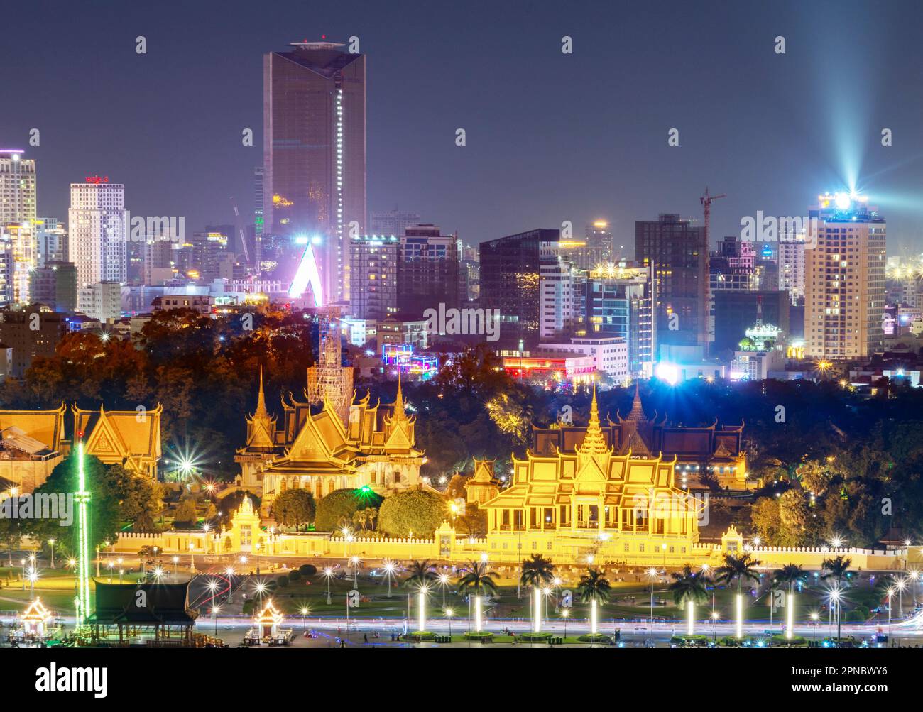 Iluminated Palace,buildings and landmarks of Cambodia's capital city,it's busy Riverside,streaks of traffic headlights,palm tree lined boulevard, and Stock Photo