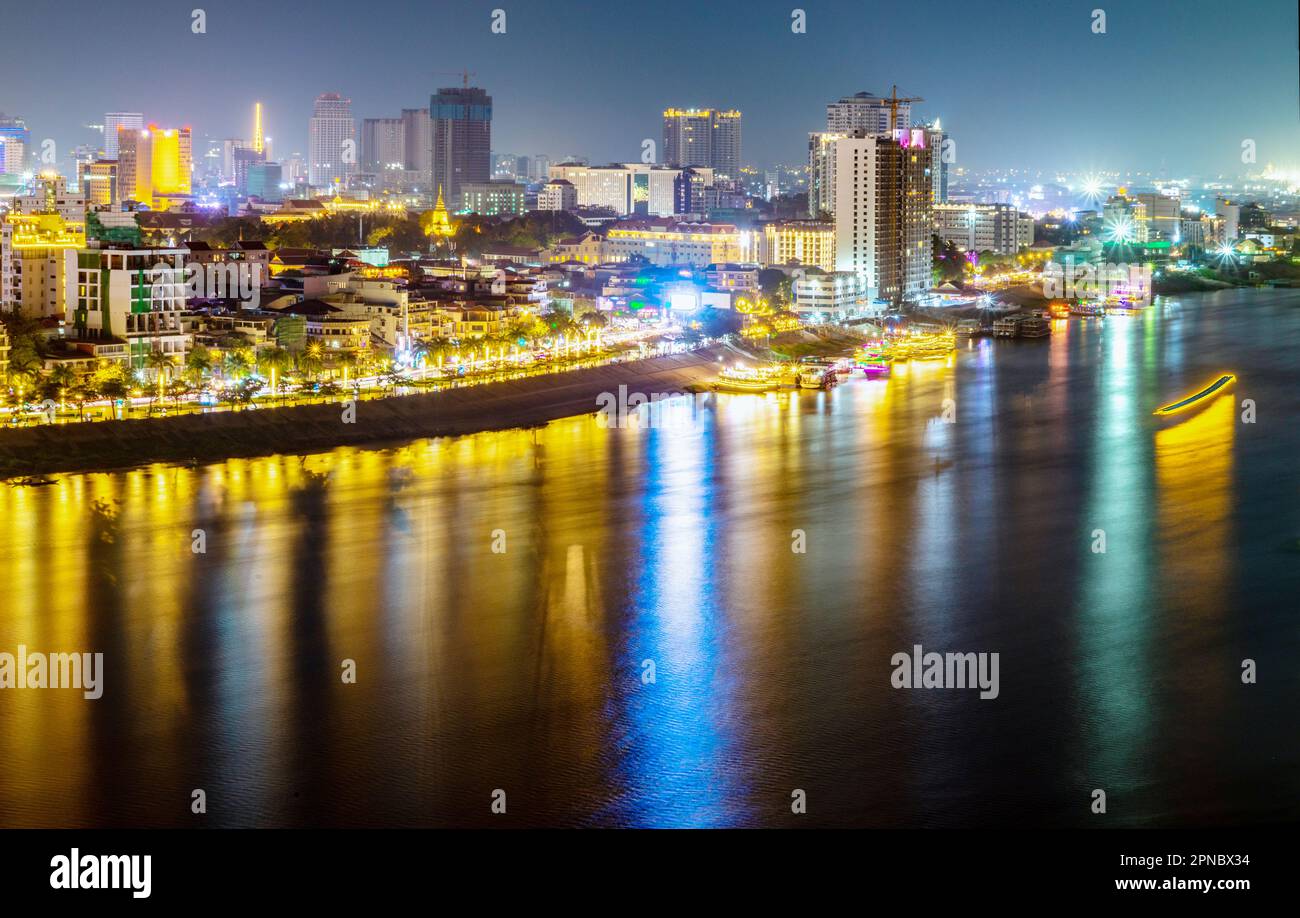 Iluminated Palace,buildings and landmarks of Cambodia's capital city,it's busy Riverside,streaks of traffic headlights,palm tree lined boulevard, and Stock Photo