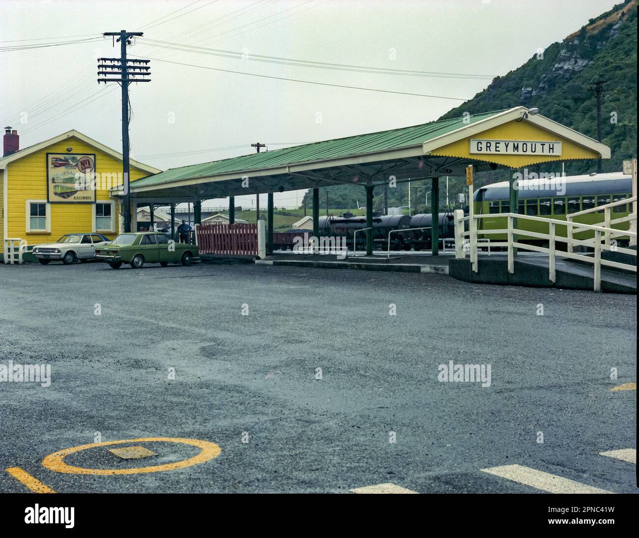 A 1981 historic image of Greymouth Railway Station on the west coast of the south island of New Zealand. In the image are two parked Ford Cortinas Stock Photo