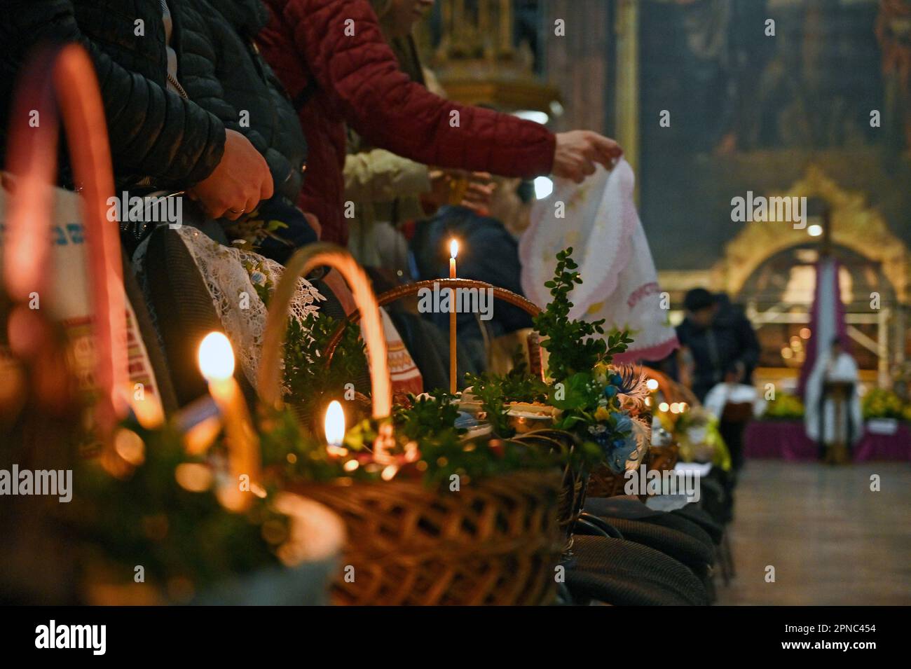 LVIV, UKRAINE APRIL 15, 2023 Devotees arrange their Easter baskets