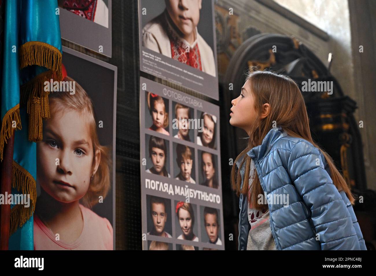 LVIV, UKRAINE - APRIL 15, 2023 - A girl looks at the photos exhibited ...