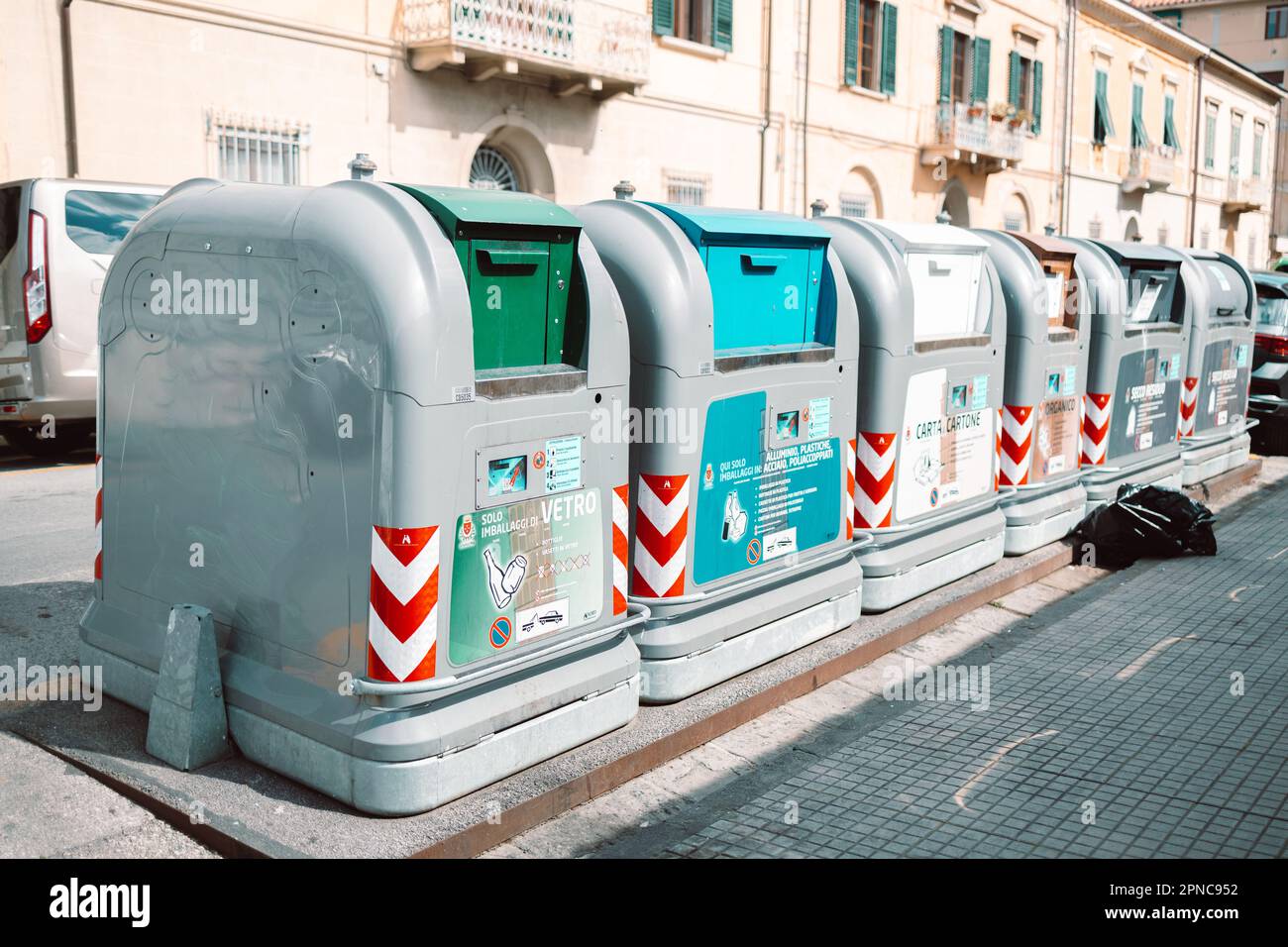 Pisa, Italy March 18, 2023 Different colors of garbage cans stand on