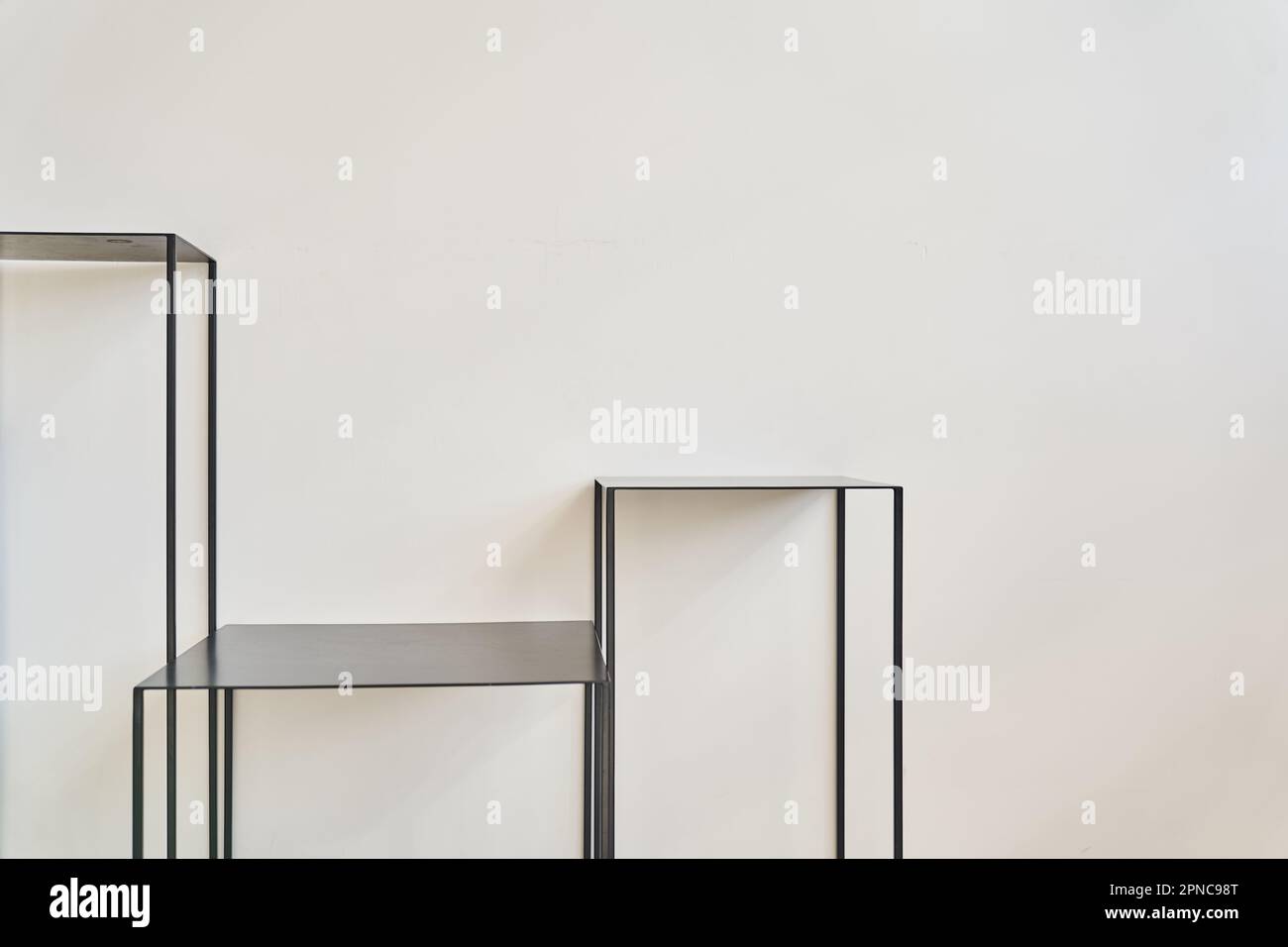 Black metal tables on a white background, layout for your product, space for your design, podium
