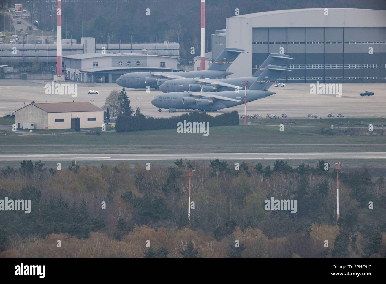 Ramstein, Germany. 18th Apr, 2023. U.S. Air Force transport planes are  parked at the U.S. Airbase in Ramstein. In June, the NATO maneuver "Air  Defender" takes place throughout Germany. Credit: Boris Roessler/dpa/Alamy