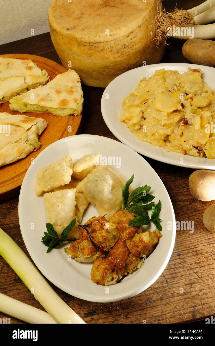 Turle (potato and mint ravioli seasoned with milk cream, garlic or leek) and stuffed onions, typical dishes of the so-called white cuisine of the hint Stock Photo