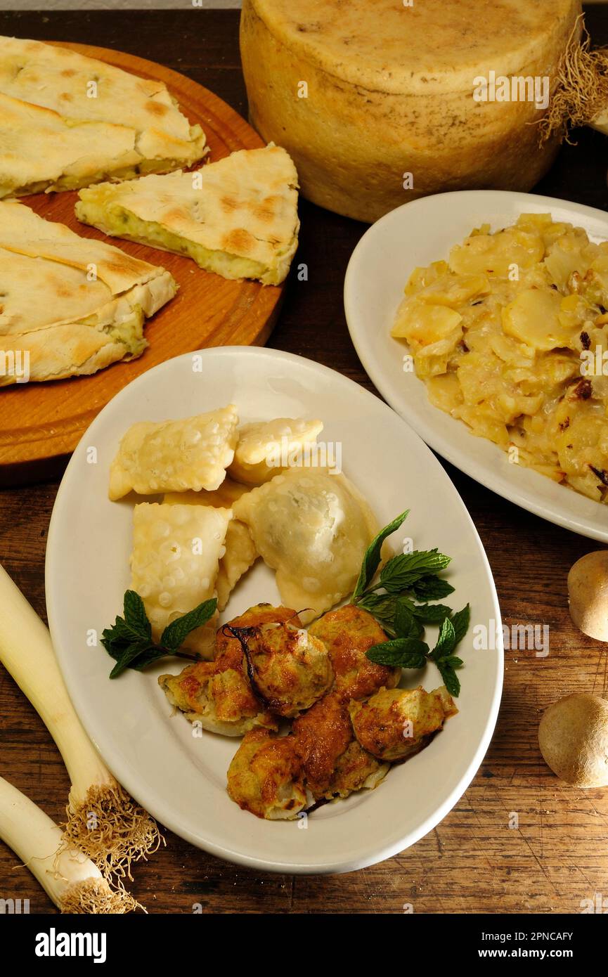 Turle (potato and mint ravioli seasoned with milk cream, garlic or leek) and stuffed onions, typical dishes of the so-called white cuisine of the hint Stock Photo