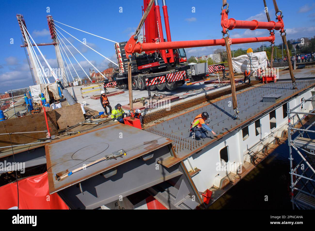 Magdeburg, Germany. 18th Apr, 2023. A crane lifts a 50ton bridge