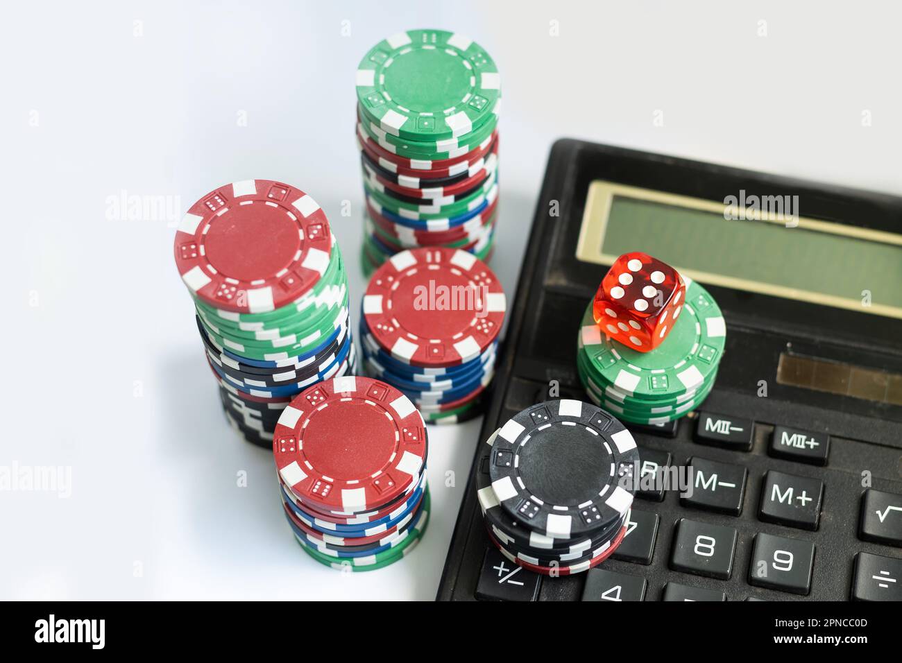 Top down view on calculator surrounded by assorted white, blue and