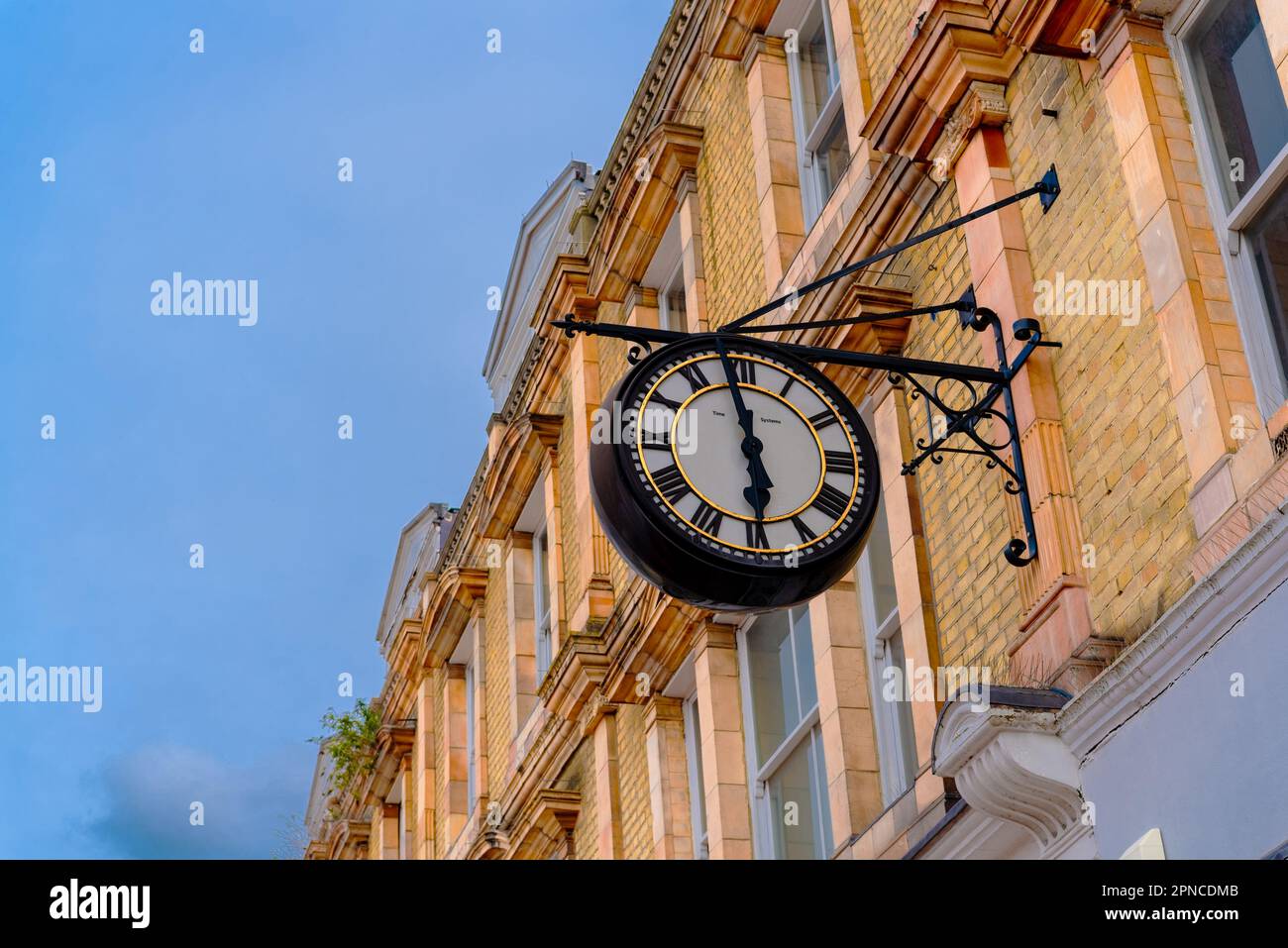 Close-up details of an old city clock on a brick house in the downtown of Bromley City in London Stock Photo