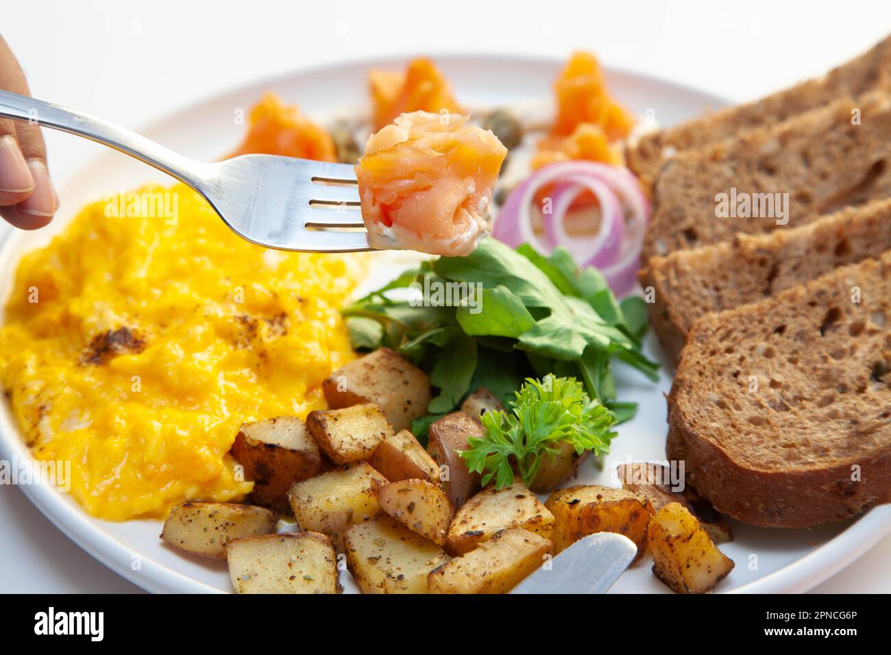 Smoked salmon with dill cream capers and scrambled eggs with rye bread