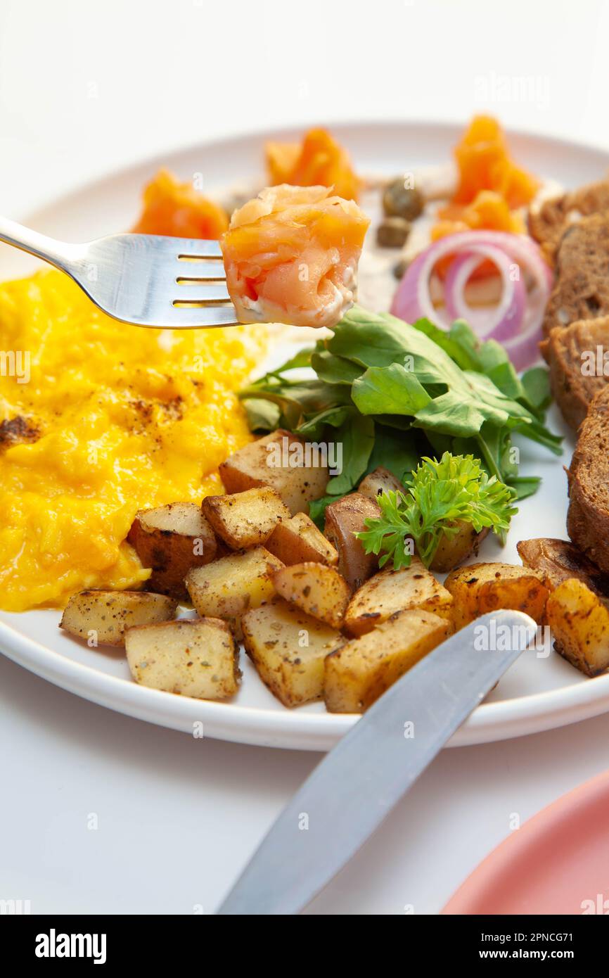 Smoked salmon with dill cream capers and scrambled eggs with rye bread