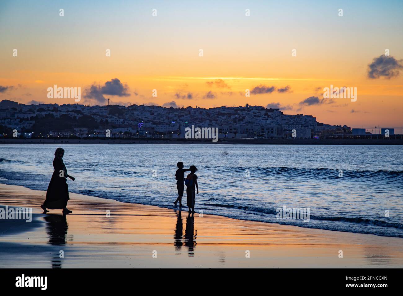 Tangier, Morocco 2022: kids silhouette in a scenic sunset in the seafront promenade Stock Photo