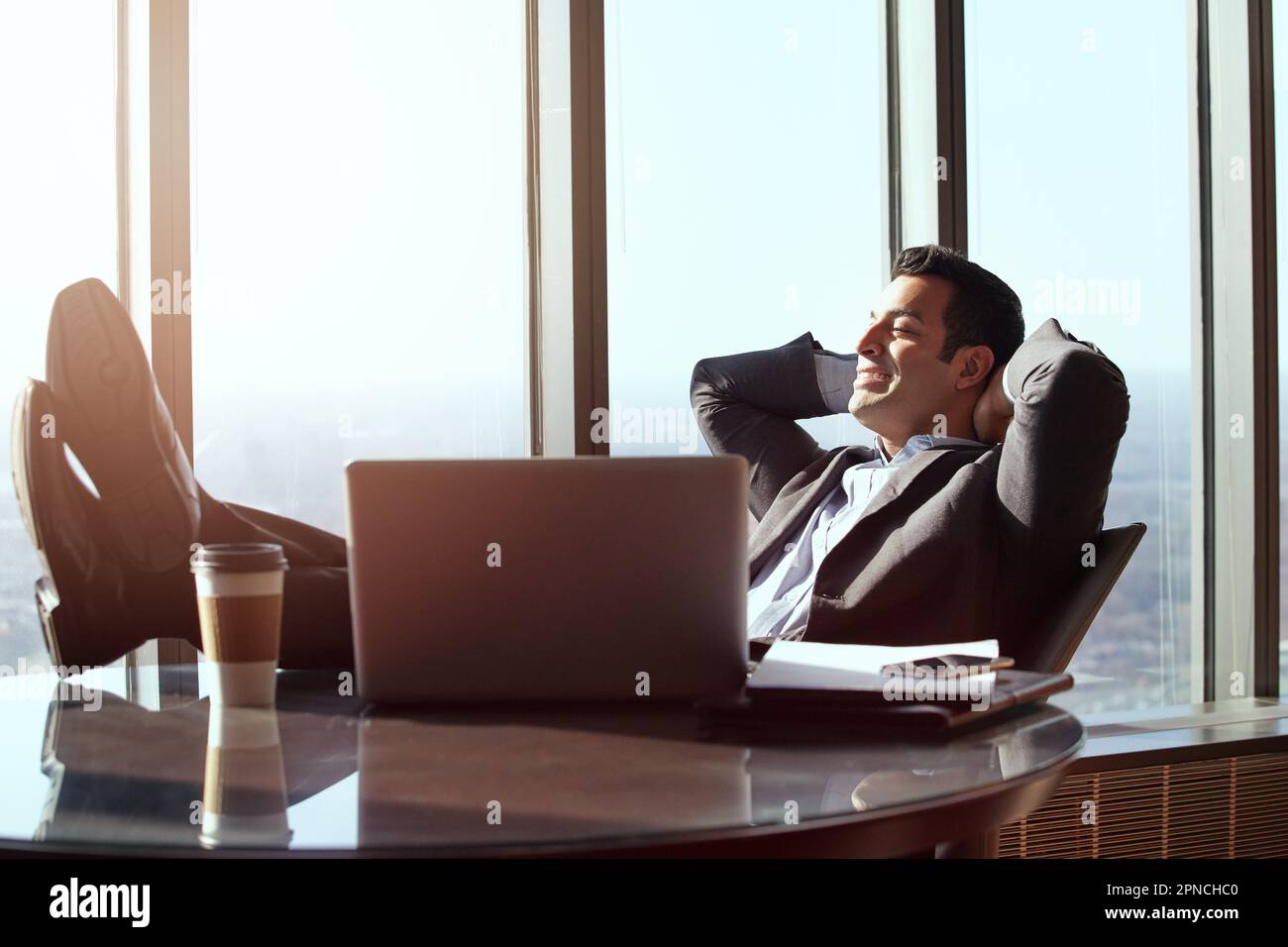 Feeling relaxed. a handsome young businessman looking relaxed while sitting in his office. Stock Photo