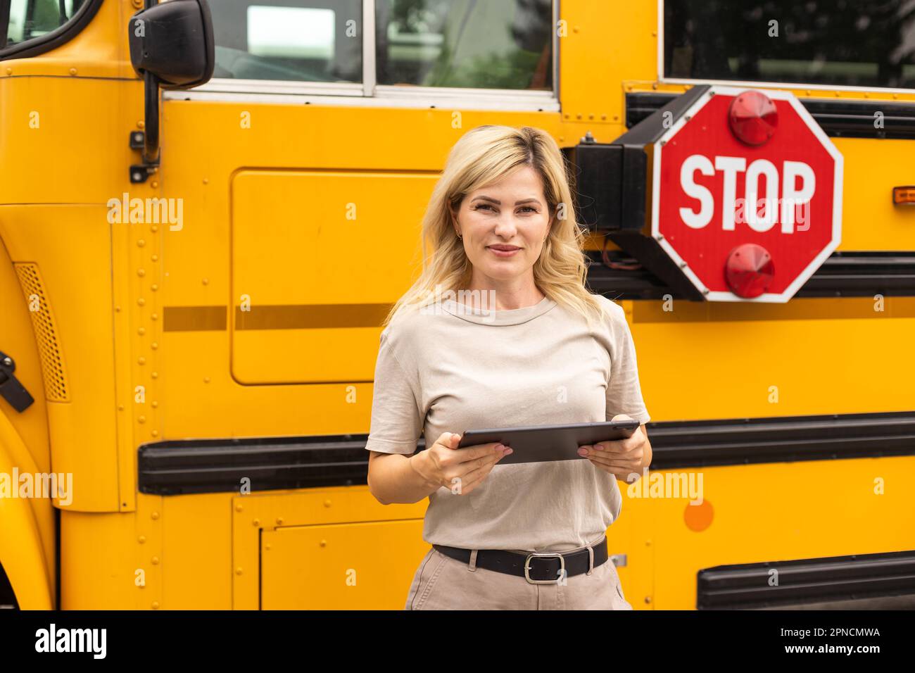 Portrait of female teacher near the school bus Stock Photo - Alamy