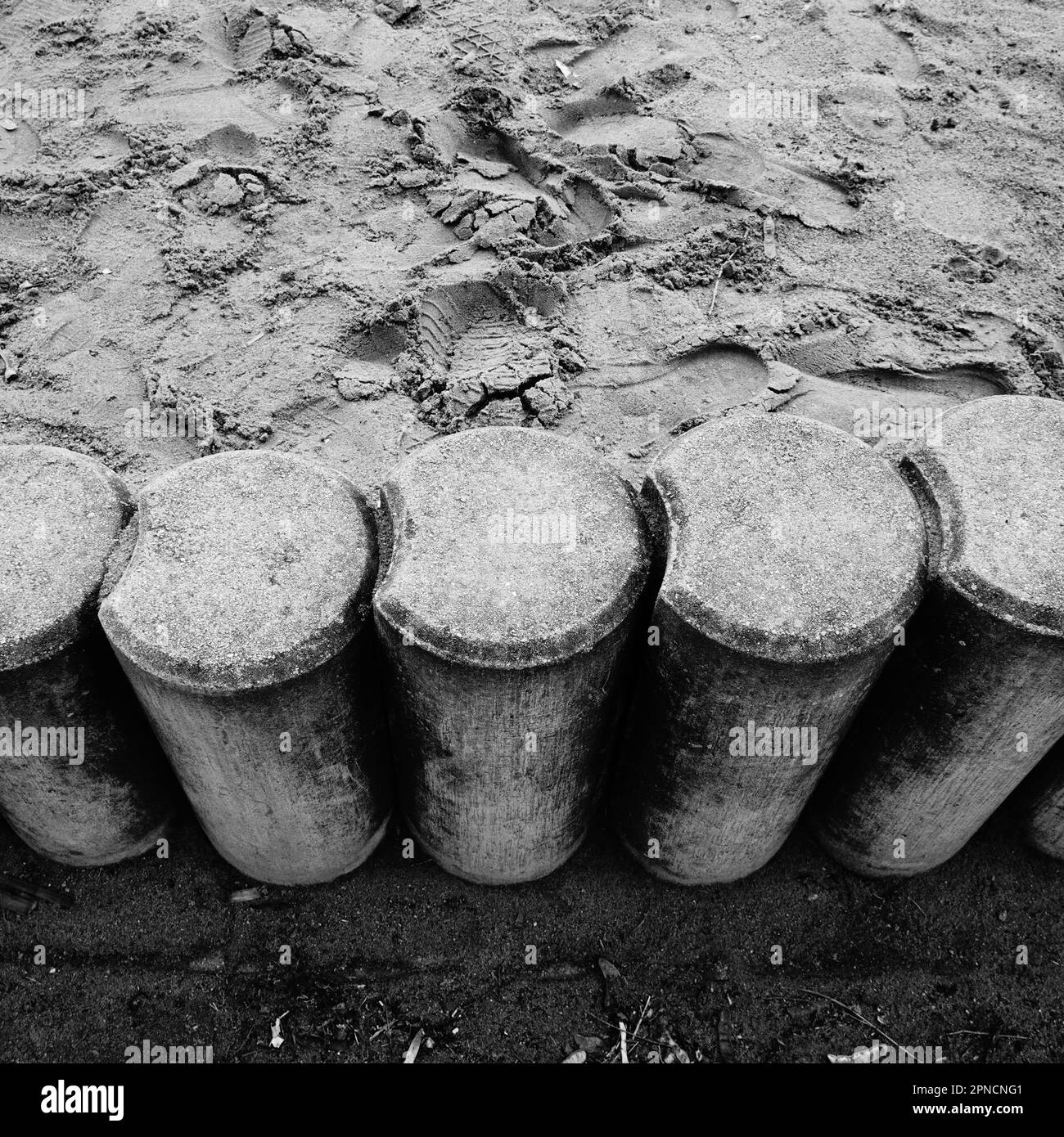 A high-resolution, black and white image of a wooden fence, composed of vertical posts Stock Photo