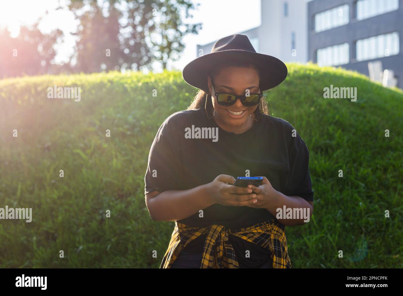 Close up portrait of happy african american young woman browsing social ...