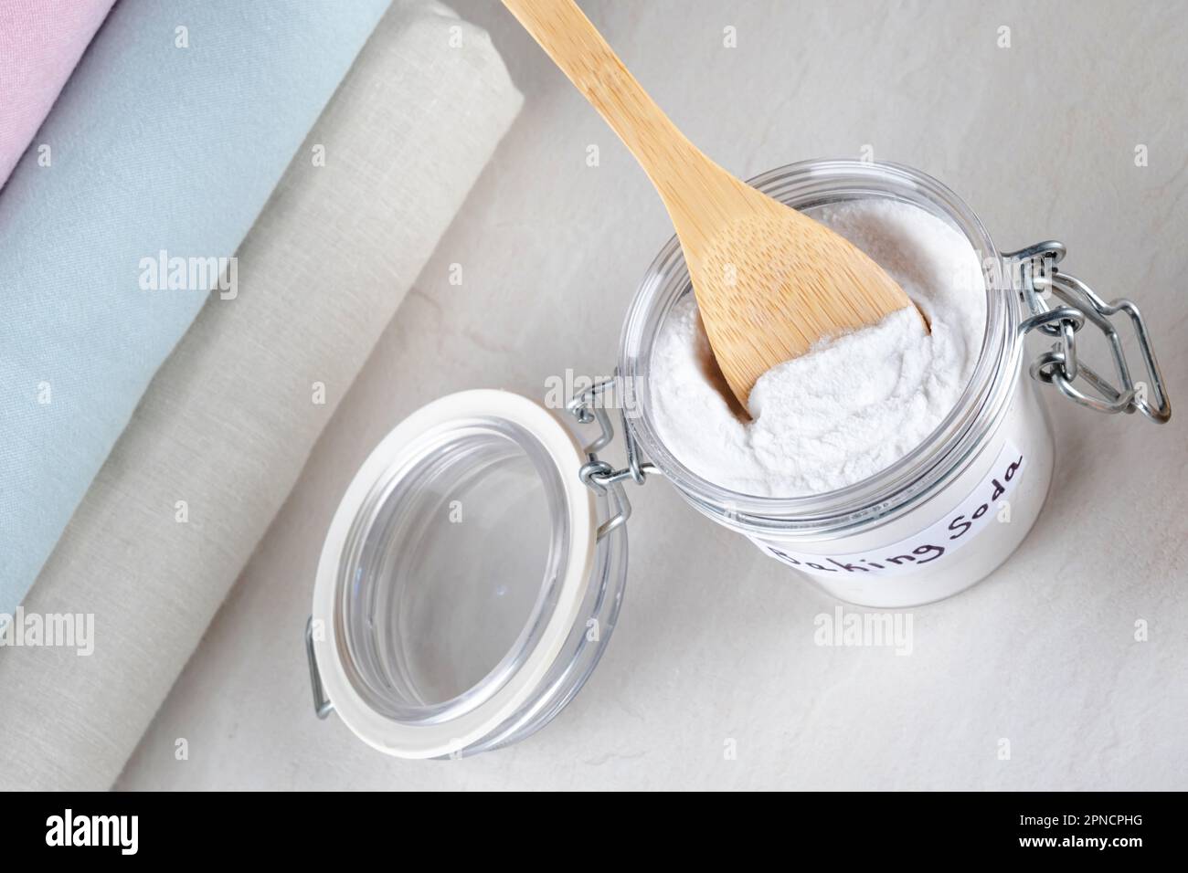 Eco friendly natural cleaner baking soda on a white table. isolated. top view. The concept of cleaning clothes stains Stock Photo