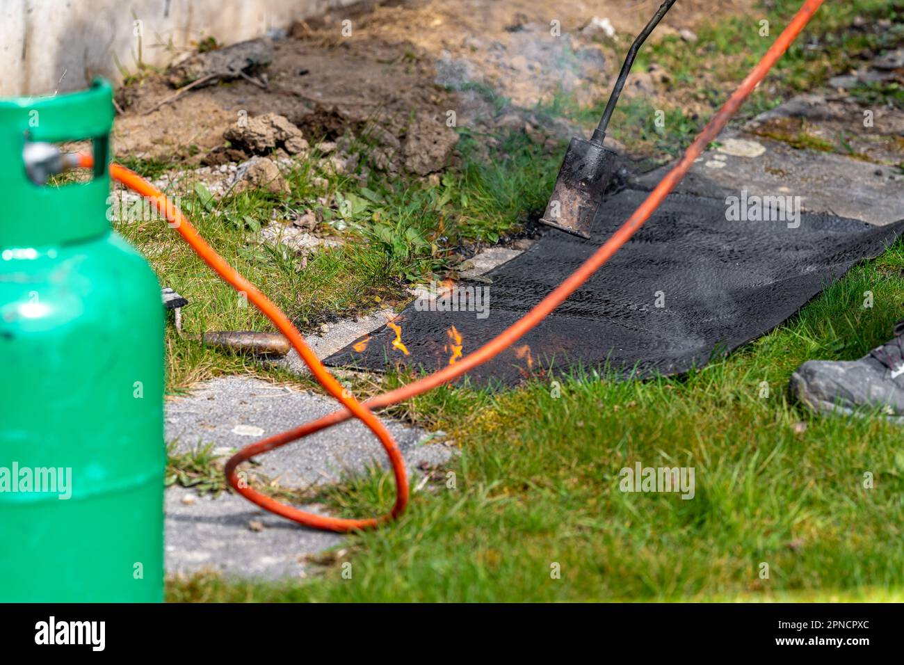 heating asphalt belts for waterproofing the foundation of the house