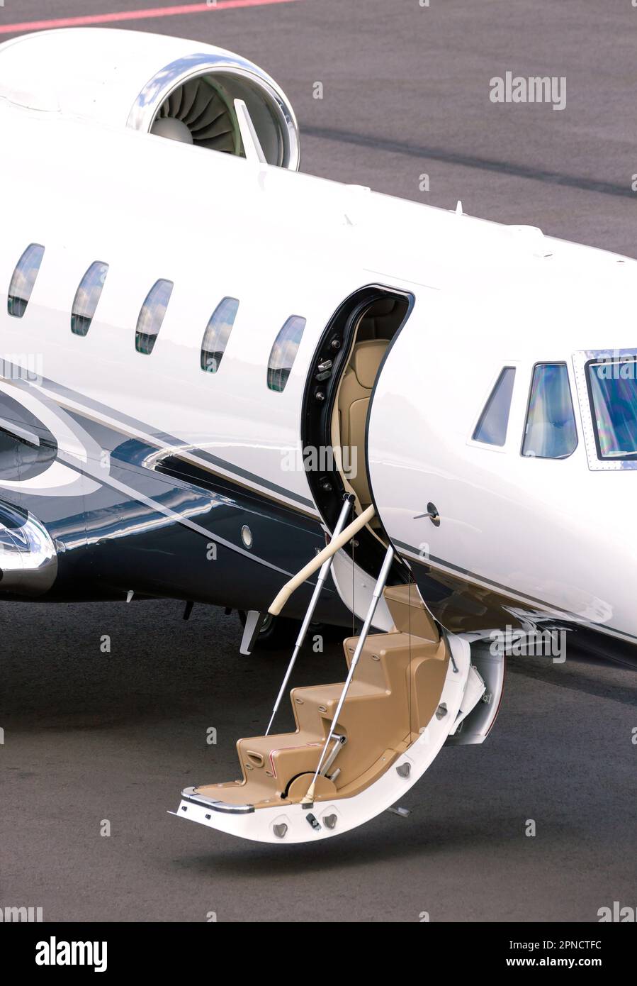 Modern corporate business jet on the tarmac of an airport. Stock Photo