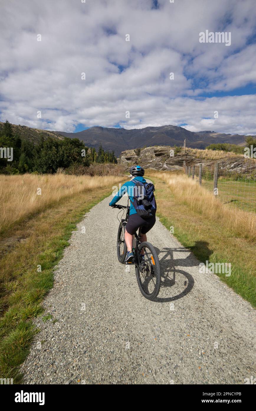 Female cyclist on the gravel track from Arrowtown to Queenstown, South