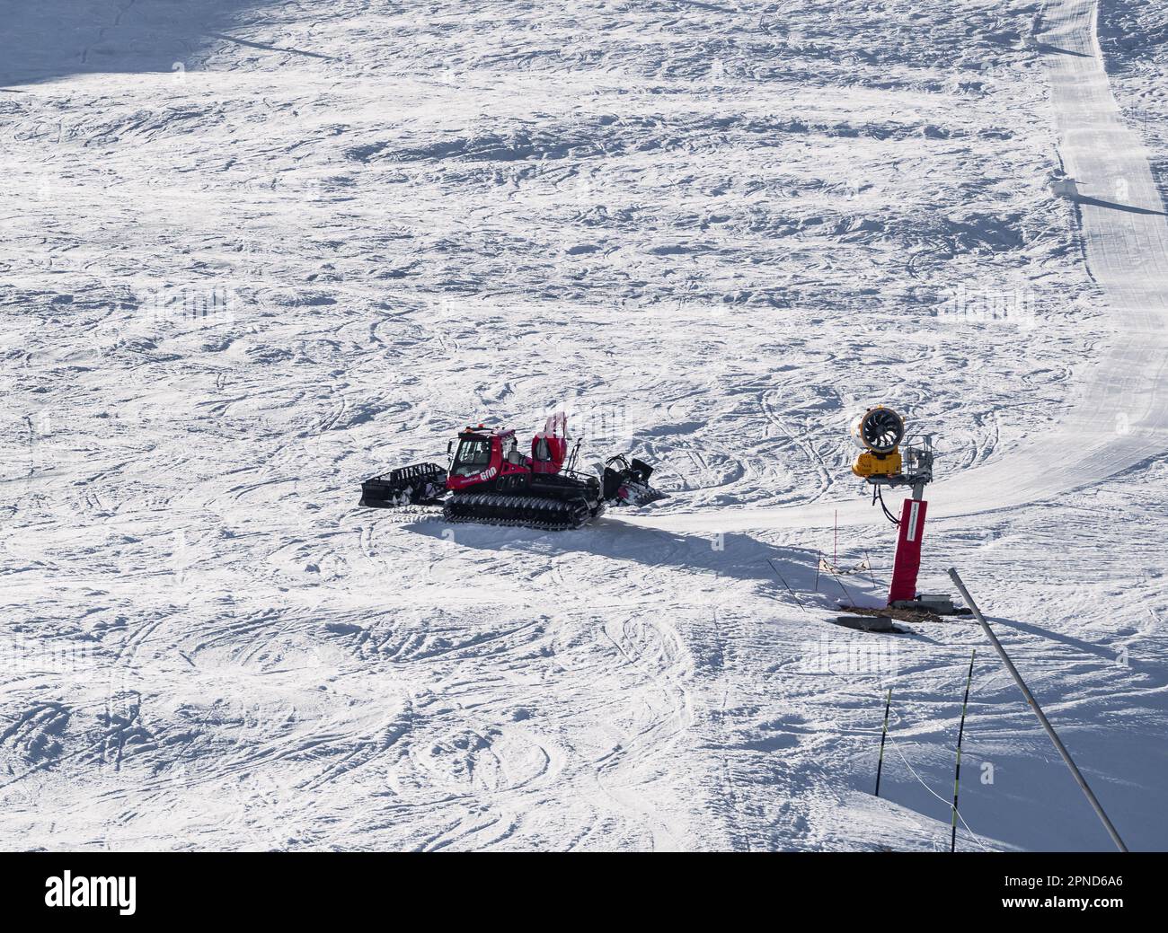 Huez, France - 9 April 2023: Snowcat, ratrack PistenBully - machine for snow preparation while working in Alpe D'huez Stock Photo