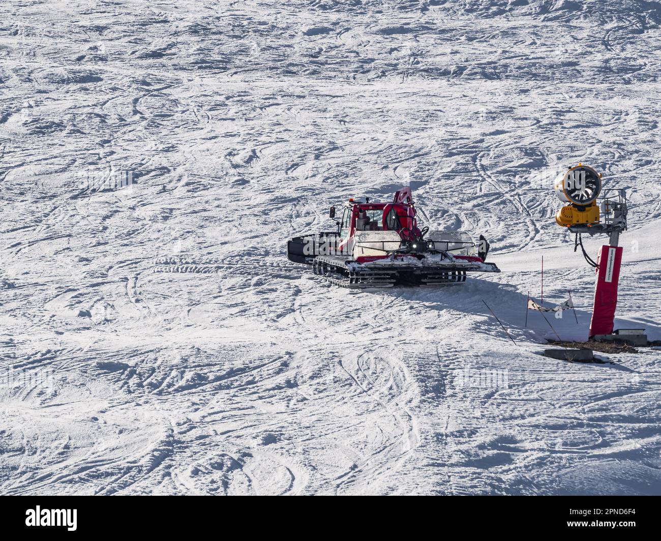 Huez, France - 9 April 2023: Snowcat, ratrack PistenBully - machine for snow preparation while working in Alpe D'huez Stock Photo