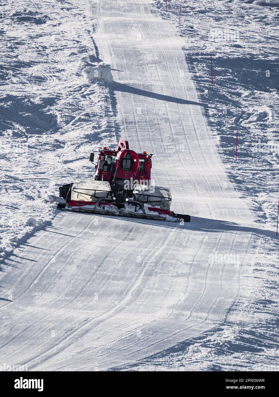 Huez, France - 9 April 2023: Snowcat, ratrack PistenBully - machine for snow preparation while working in Alpe D'huez Stock Photo