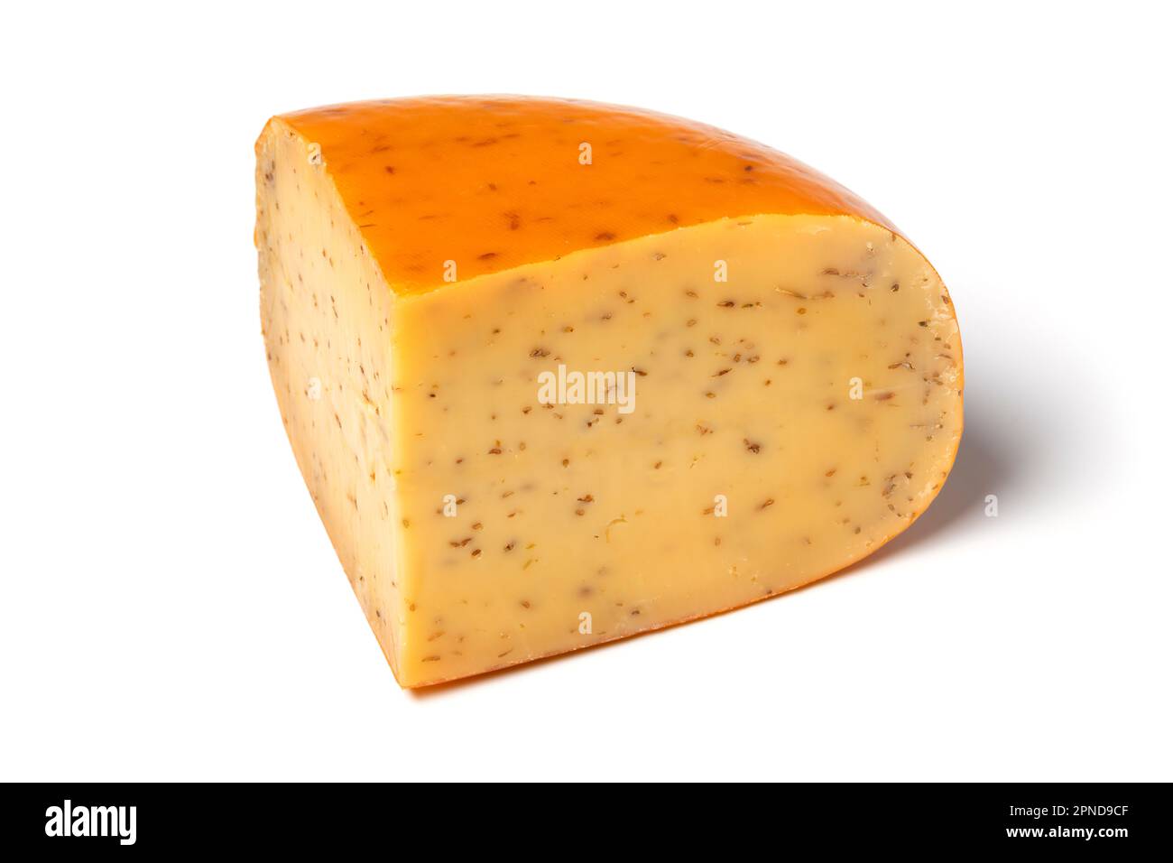 Piece of traditional mature Dutch cumin cheese isolated on white