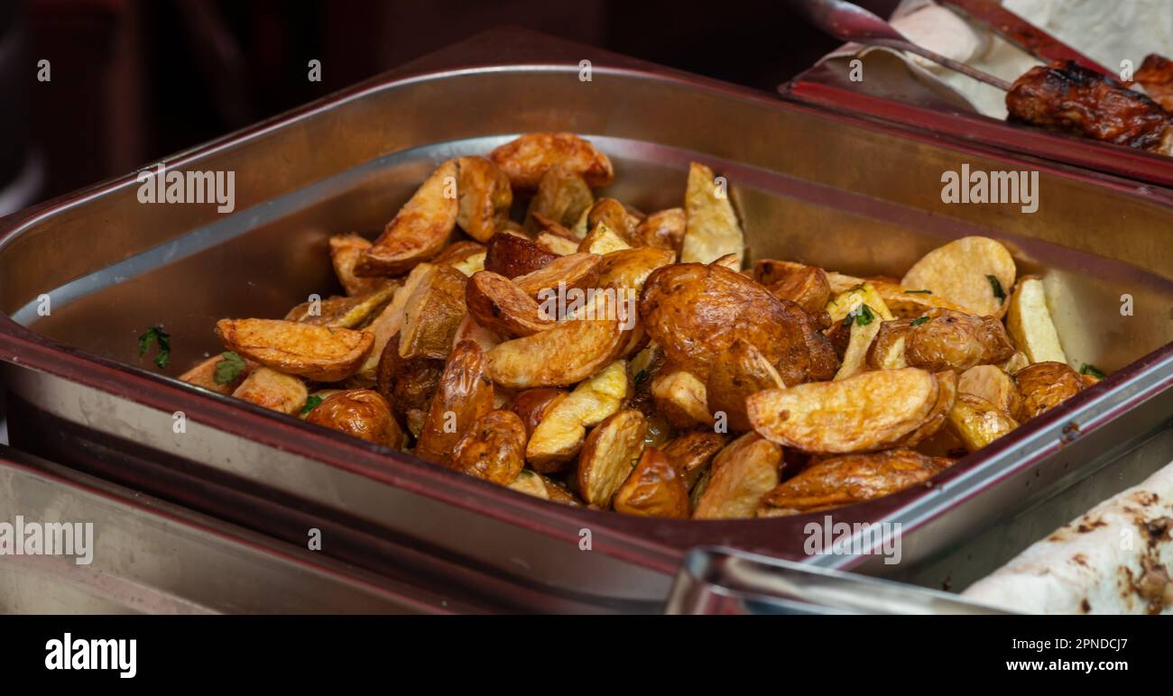 delicious grilled fried potatoes. street food. potat. Stock Photo