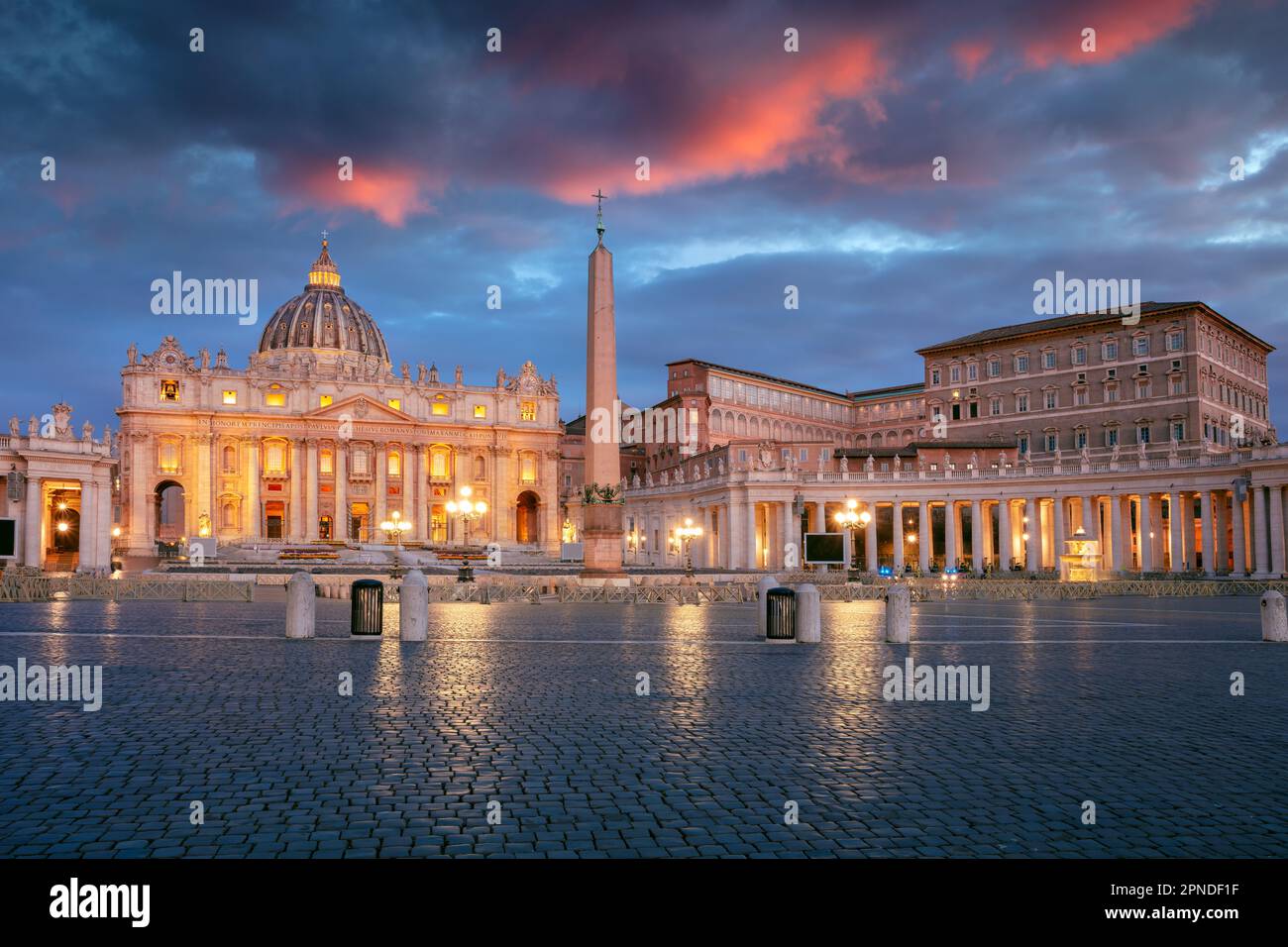 Vatican City, Rome, Italy. Cityscape image of illuminated Saint Peter's Basilica and St. Peter's Square, Vatican City, Rome, Italy at sunrise. Stock Photo