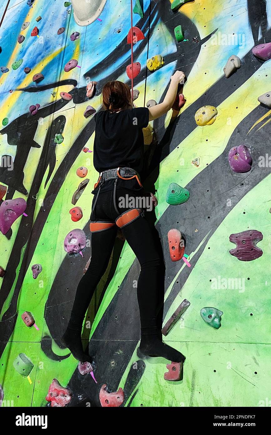 girl climbing up the wall of the training climbing wall Stock Photo Alamy
