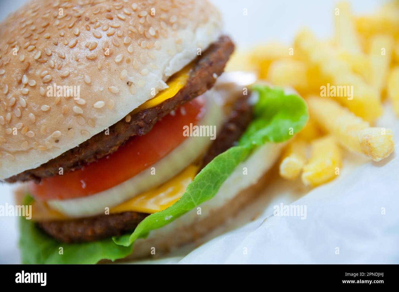 Double Burger served with potato chips Stock Photo - Alamy