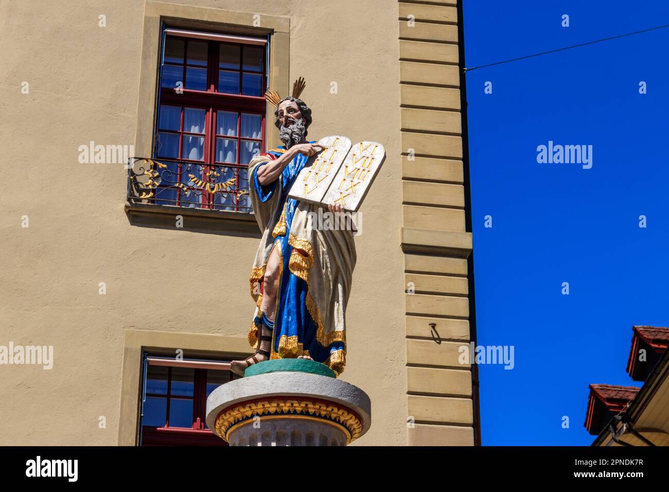 Moses Fountain (Mosesbrunnen) is a fountain on Munsterplatz in the Old City of Bern, Switzerland. Figure of Moses holding Ten Commandments Stock Photo