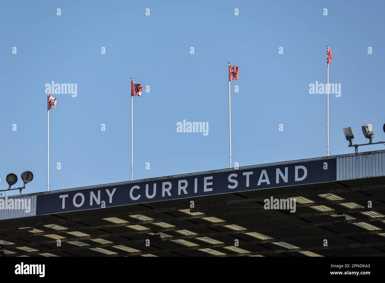 Sheffield United flags blow in the strong winds on the Tony Currie