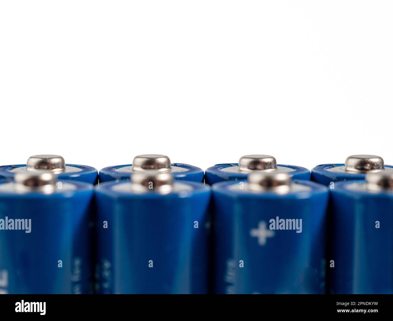 Alkaline batteries on a light background. The concept of energy sources and their use. Lots of