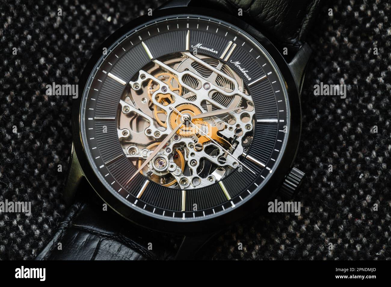Uglich, Russia - February 1, 2021: Black clock face with steel details of Mikhail Moskvin skeleton watch by Uglich Watch Factory Stock Photo
