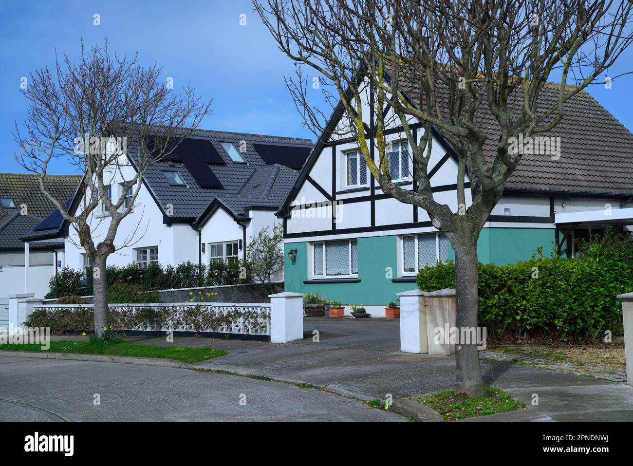 Suburban street with detached stucco houses with gables Stock Photo