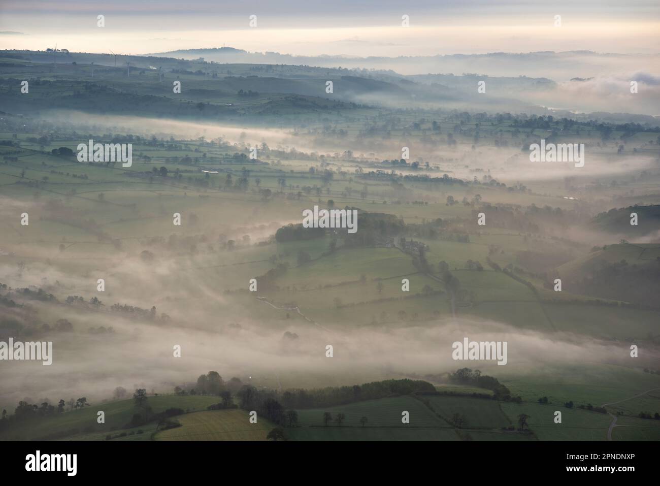 A misty spring morning with fog in the valleys from a hot air ballon flight near Tissington, in the White Peak area of the English Peak District Stock Photo