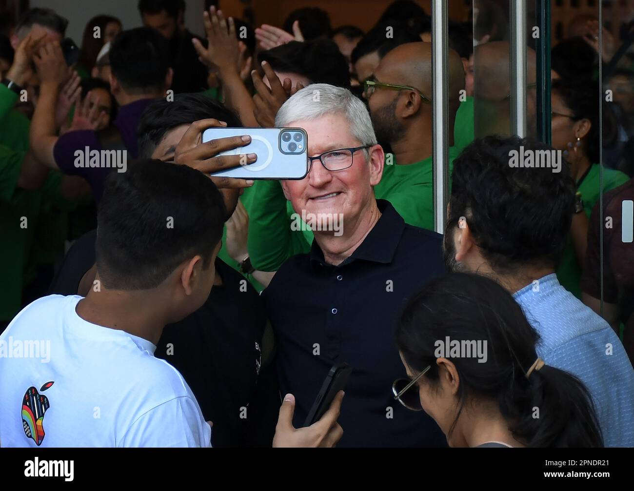 Mumbai, India. 18th Apr, 2023. A man takes a selfie with Tim Cook, Apple's Chief Executive