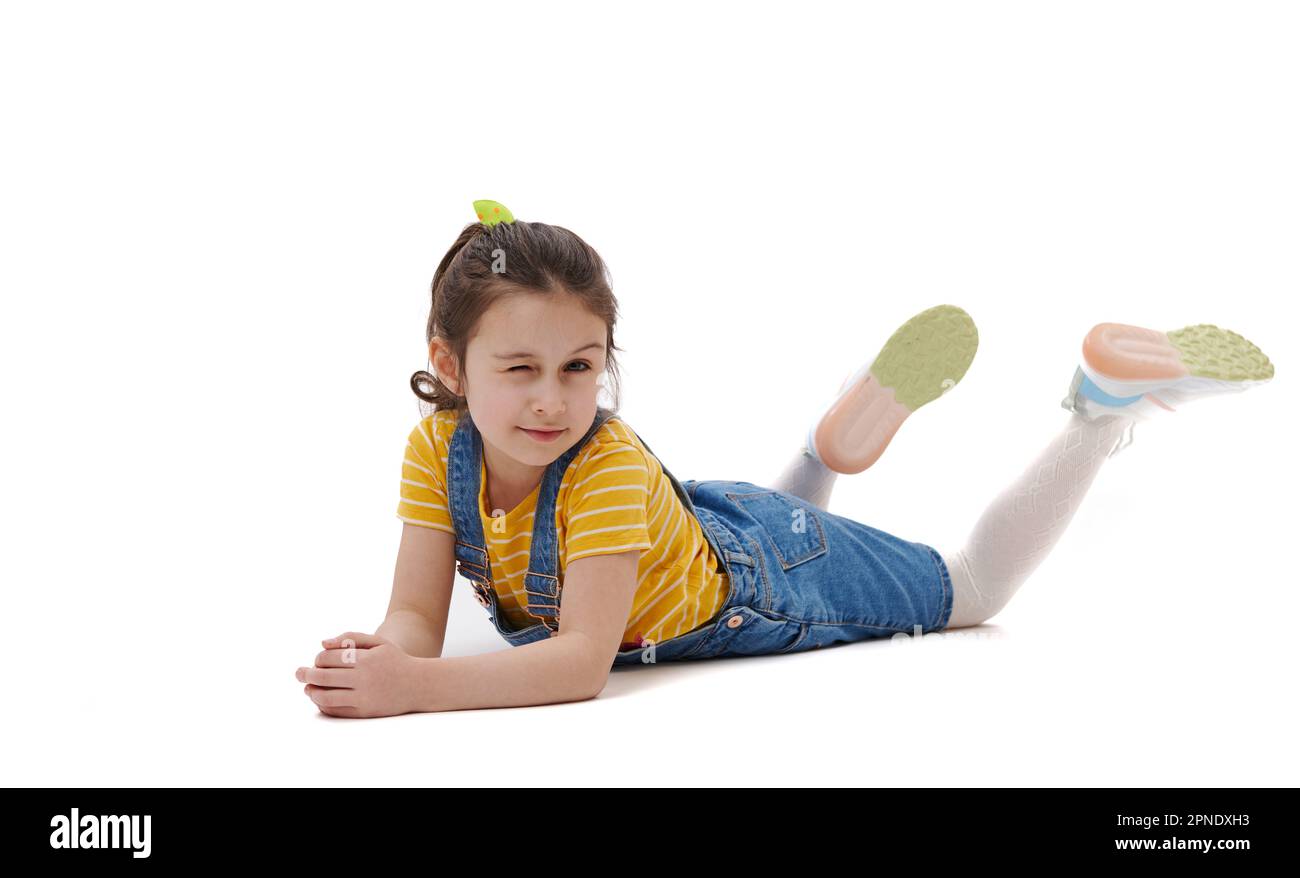 Kid Winking Adorable Caucasian little kid girl winking looking at camera, lying on ...