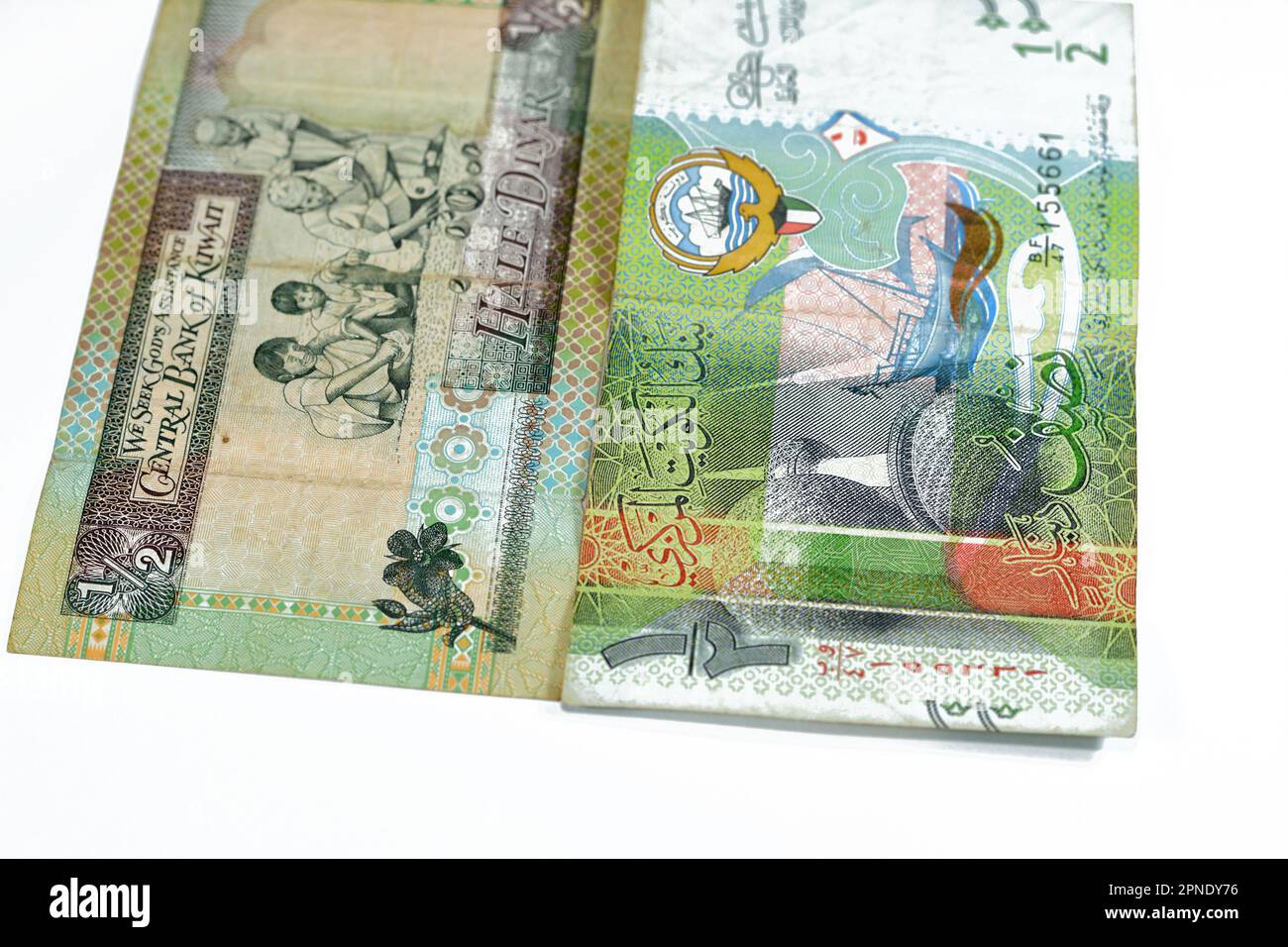 Old and new Kuwaiti half dinar bill banknotes money coat of arms of Kuwait, vignette changers' stalls, vignette of coffee pot, Kuwait Towers and a dho Stock Photo