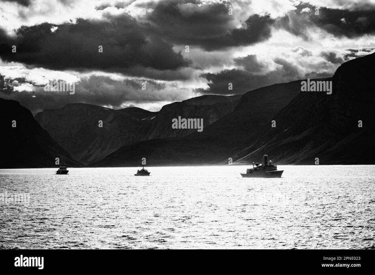 Warships participating in Operation Nanook 2022 follow HMCS Margaret Brooke in line ahead formation within Saglek Fjord in northern Labrador, Canada. Stock Photo
