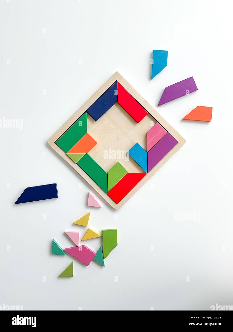 tangram game. Multicolored parts are disassembled on white table. top view Stock Photo