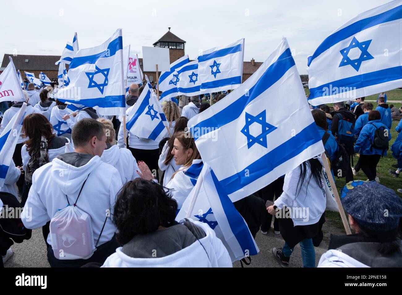 Czestochowa, Poland. 18th Apr, 2023. People with Israel flags seen in front of Birkenau- a former German Nazi concentration and extermination camp's gate. Every year thousands of Jews come to Auschwitz- Birkenau, a former German nazi concentration and extermination camp to participate in the International March of The Living. Survivors from Holocaust also participate in the march. Credit: SOPA Images Limited/Alamy Live News Stock Photo