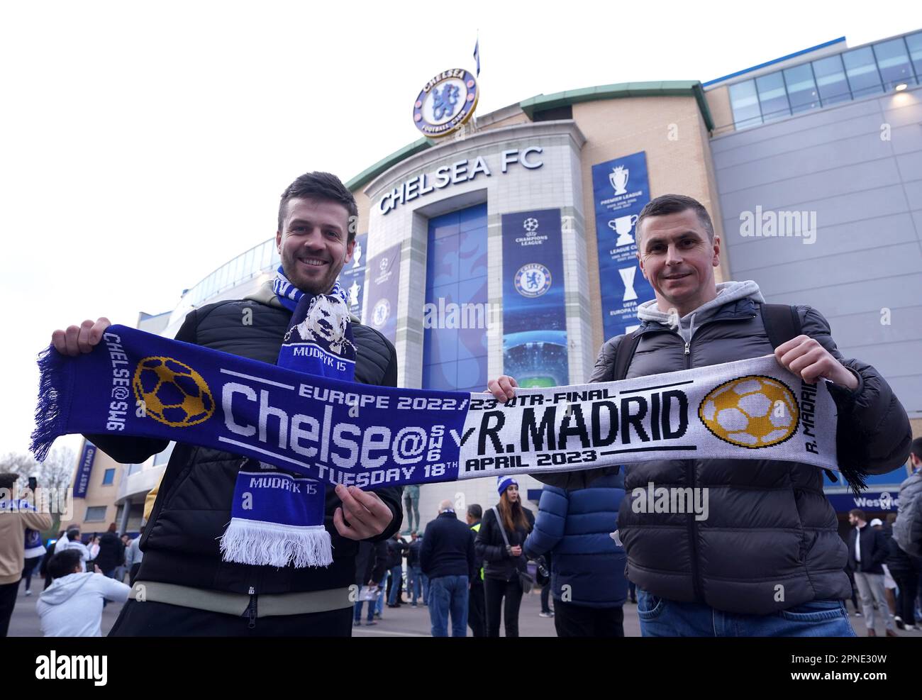 Fans with a match half and half scarf outside the ground ahead of the UEFA Champions League quarter-final second leg match at Stamford Bridge, London. Picture date: Tuesday April 18, 2023. Stock Photo