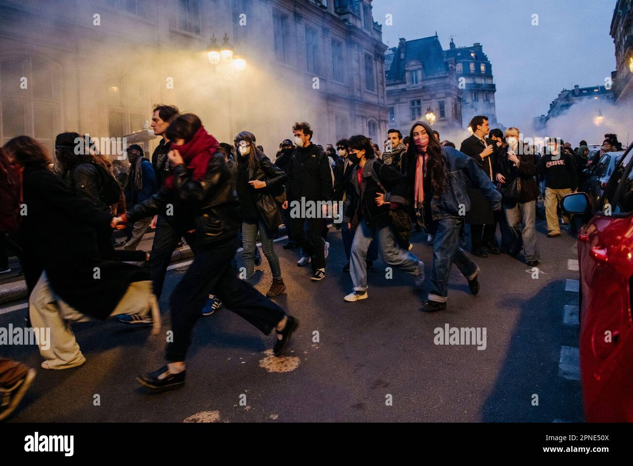 Jan Schmidt-Whitley/Le Pictorium - 17/4/2023  -  France / Paris / Paris  -  La police tente de contenir la foule en lancant des grenades lacrymogenes. Plusieurs milliers de personnes se sont reunies devant la mairie du 10e arrondissement de Paris pour protester contre la politique de Emmanuel Macron et contre la reforme des retraites. Plusieurs centaines de personnes ont ensuite parcouru Paris pendant plusieurs heures en formant de multiples corteges sauvages et jouant au chat et a la souris avec les forces de l'ordre depassees par les evenements et la mobilite des groupes composes majoritaire Stock Photo