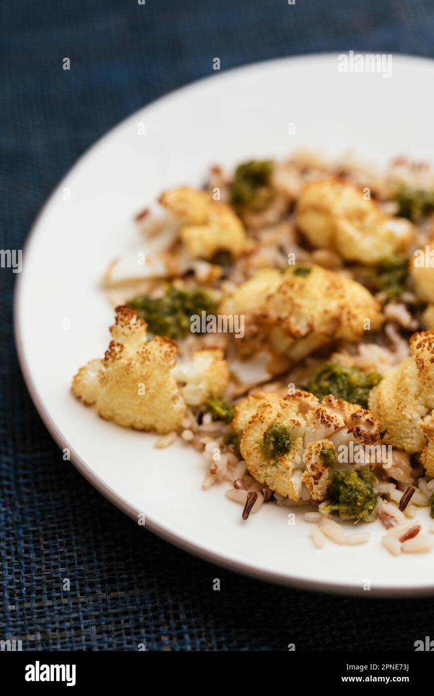 Roasted Cauliflower on Mixed Rice with Tahini and Zhoug Sauces Stock Photo