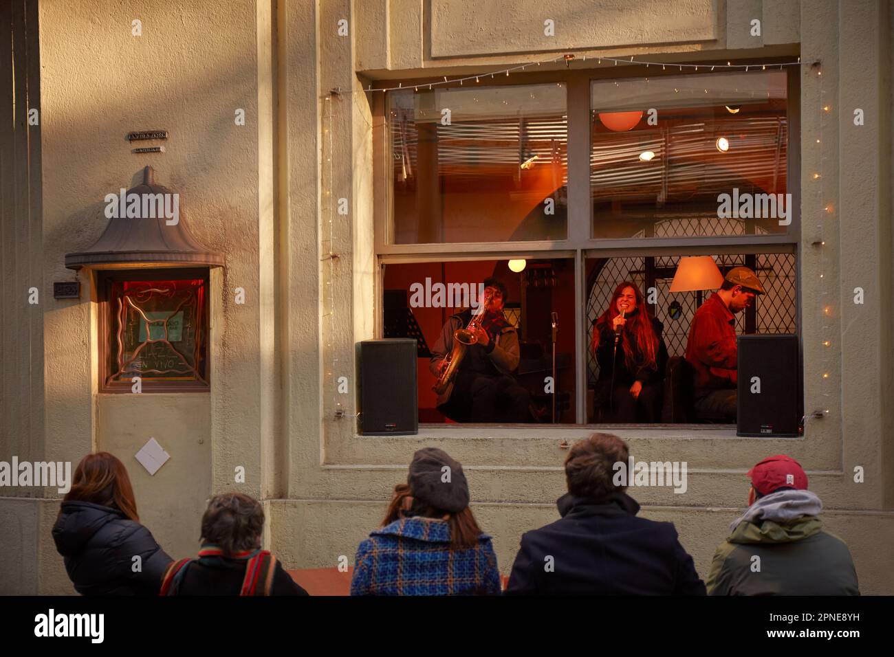 People outside the 'Virasoro Bar' looking at a Jazz live session, Palermo district, Buenos Aires, Argentina. Stock Photo