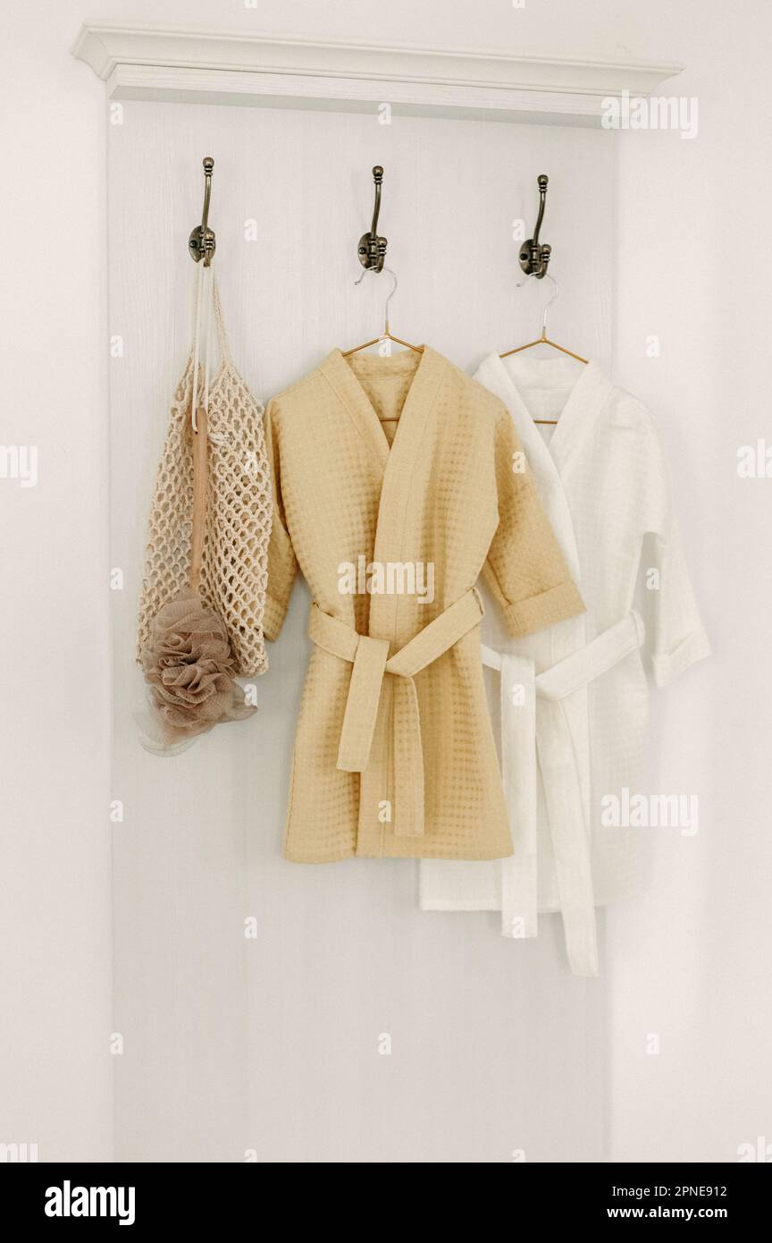 Linen bathrobes hang on a hanger in the bathroom Stock Photo - Alamy