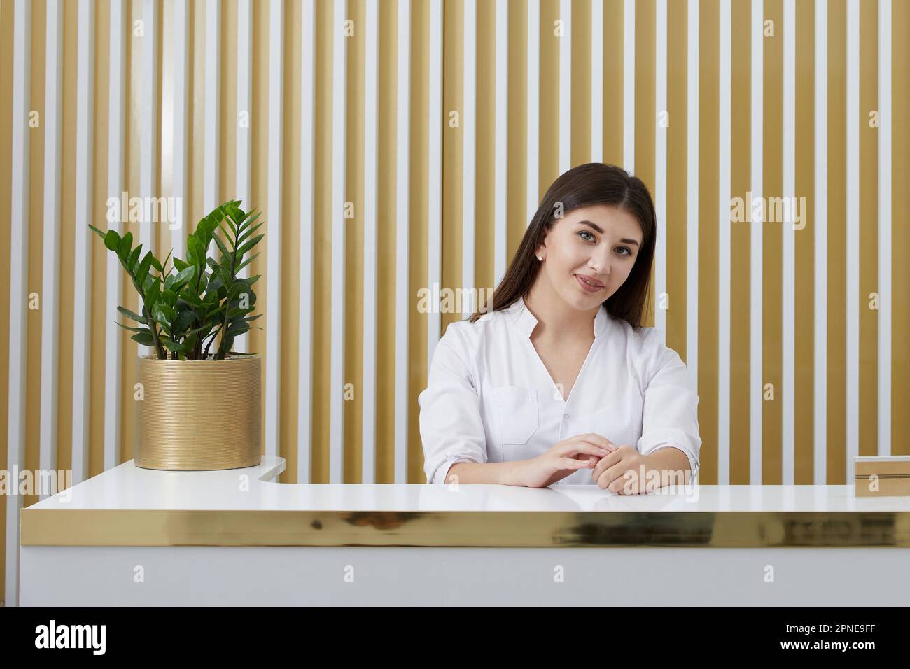 female-receptionist-at-reception-desk-in-a-modern-office-lobby-stock